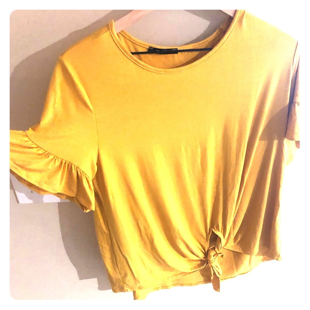 Mustard color tie front top with flair sleeves.